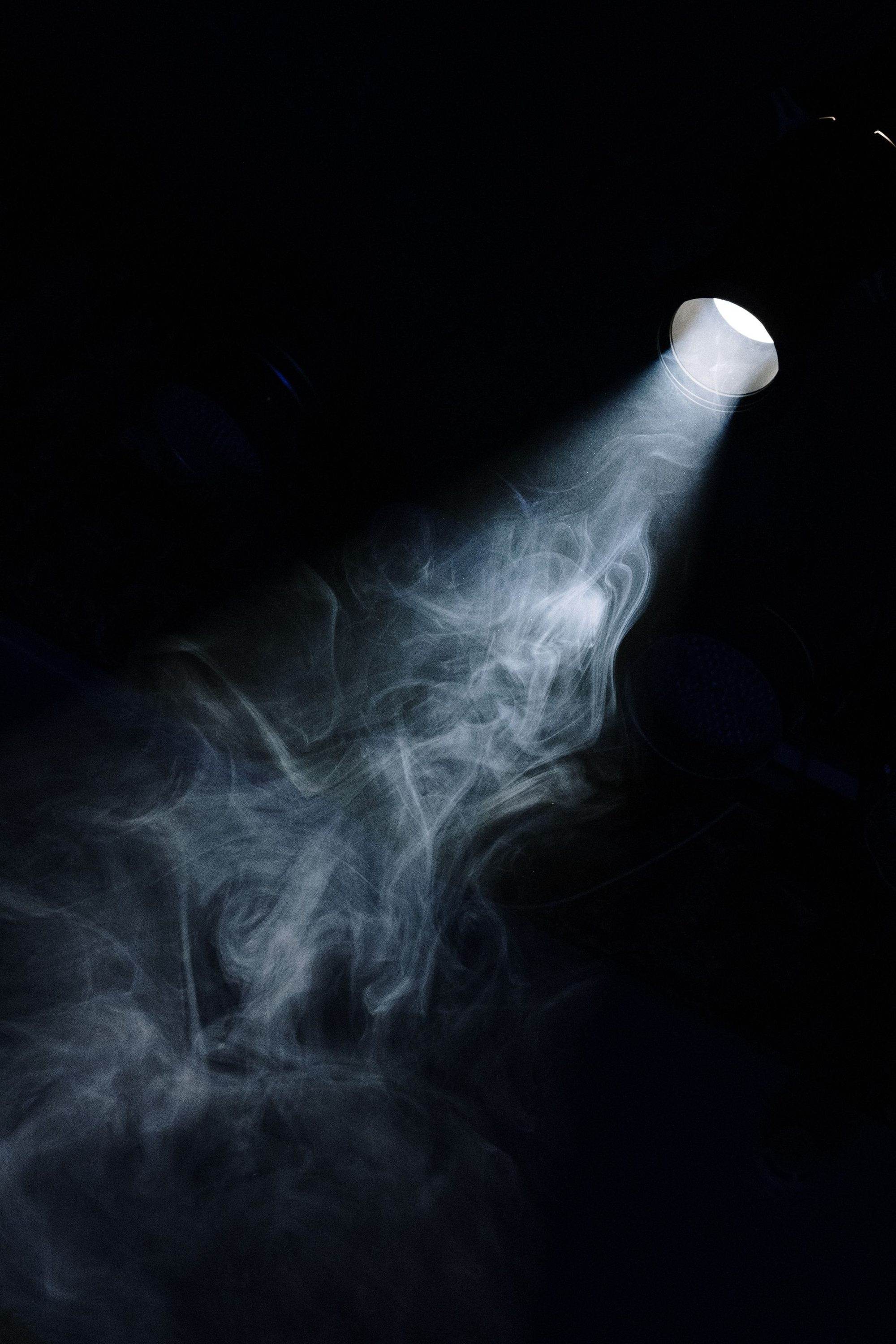 A projector beam cutting through haze in the dark